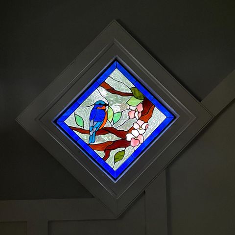 stained glass bird in a tree